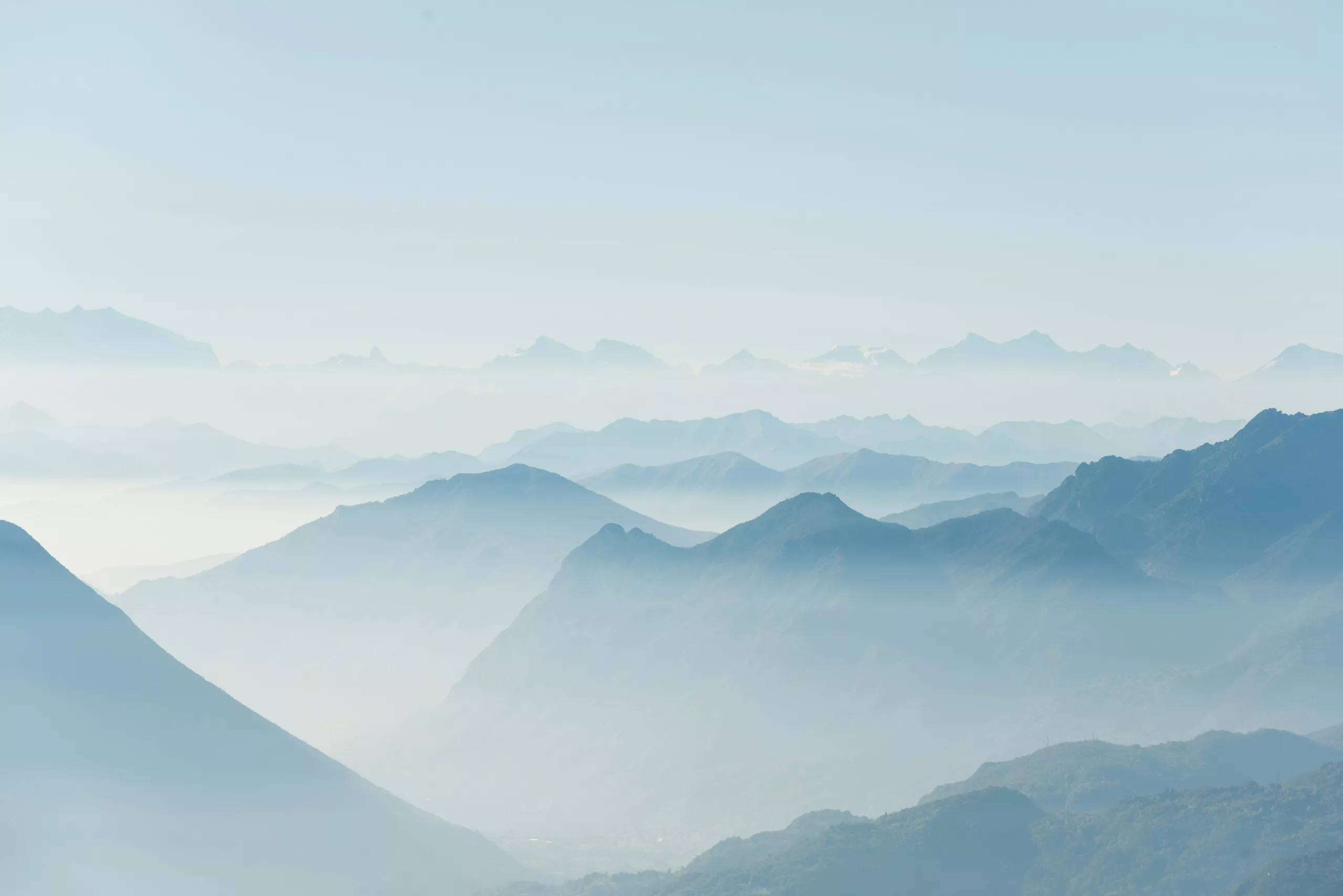 Soft blue misty mountain ranges at dawn
