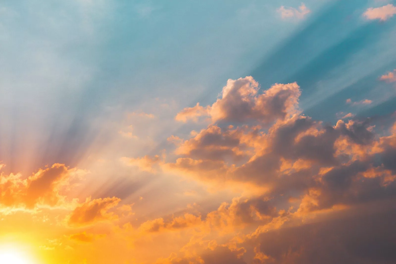 Sun rays streaming through clouds at golden hour
