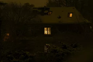 A house at night with illuminated windows